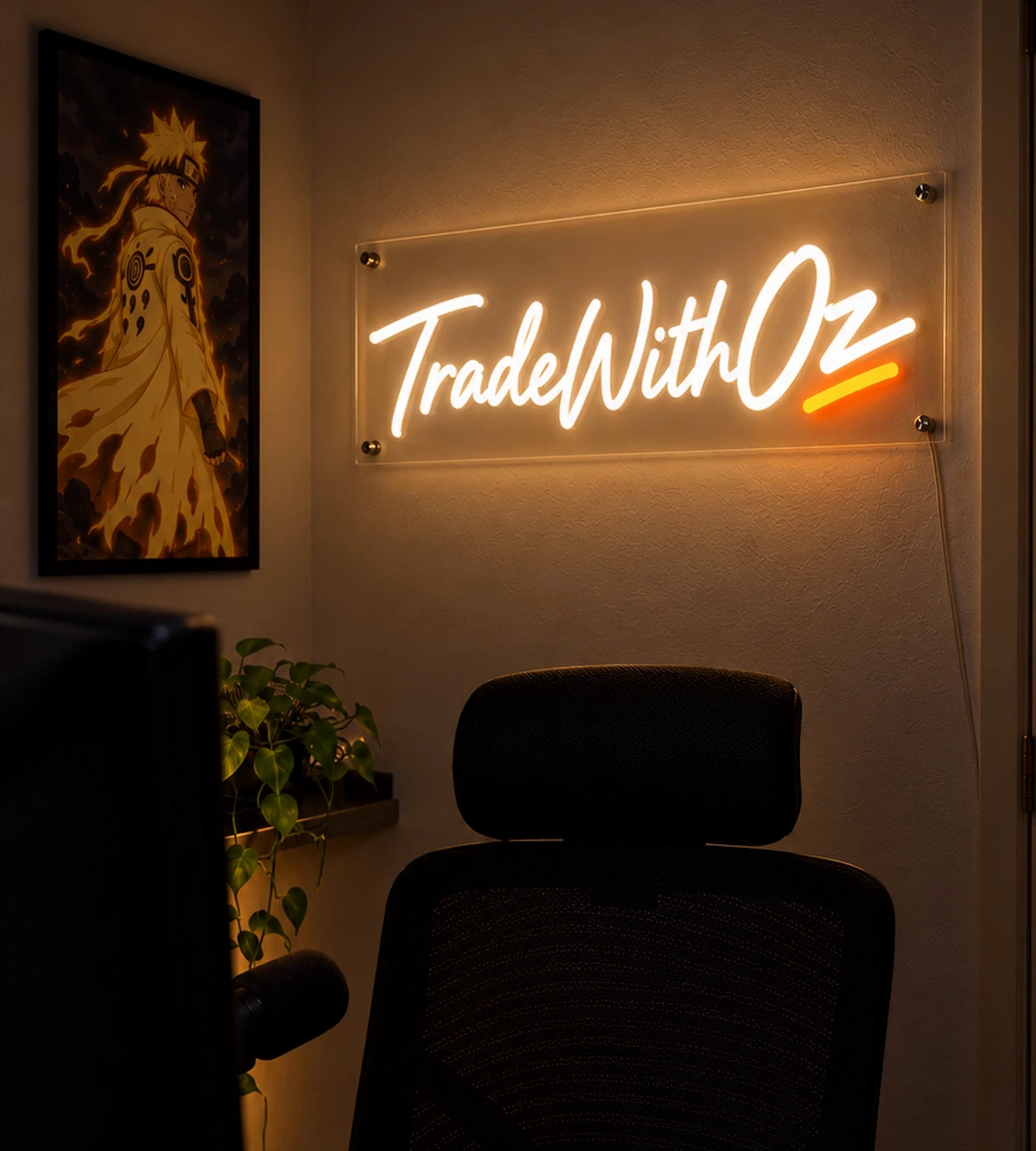 A warm studio scene with the illuminated TradeWithOz neon sign above a trading desk and chair.
